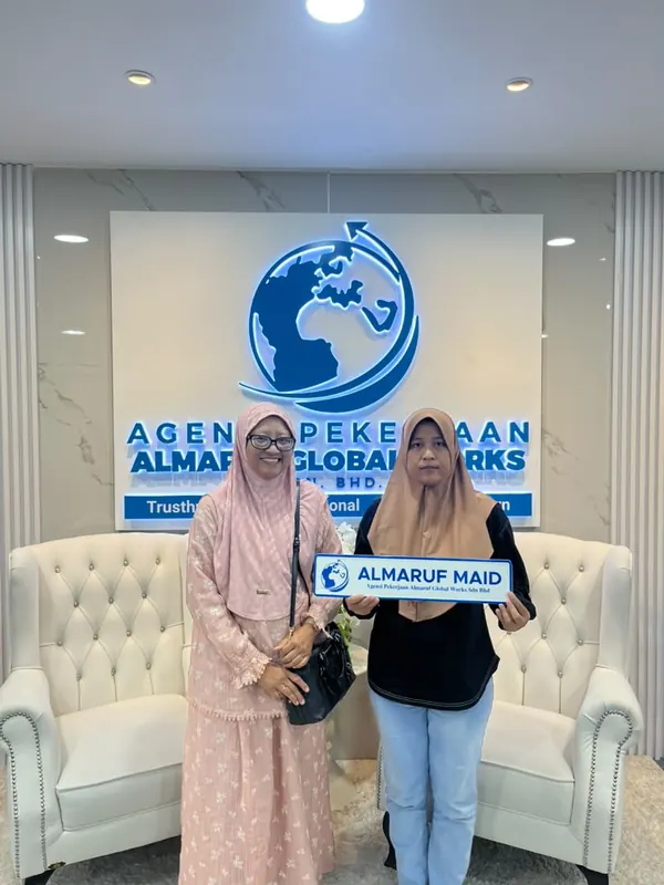 An employer with their new Almaruf helper on handover day