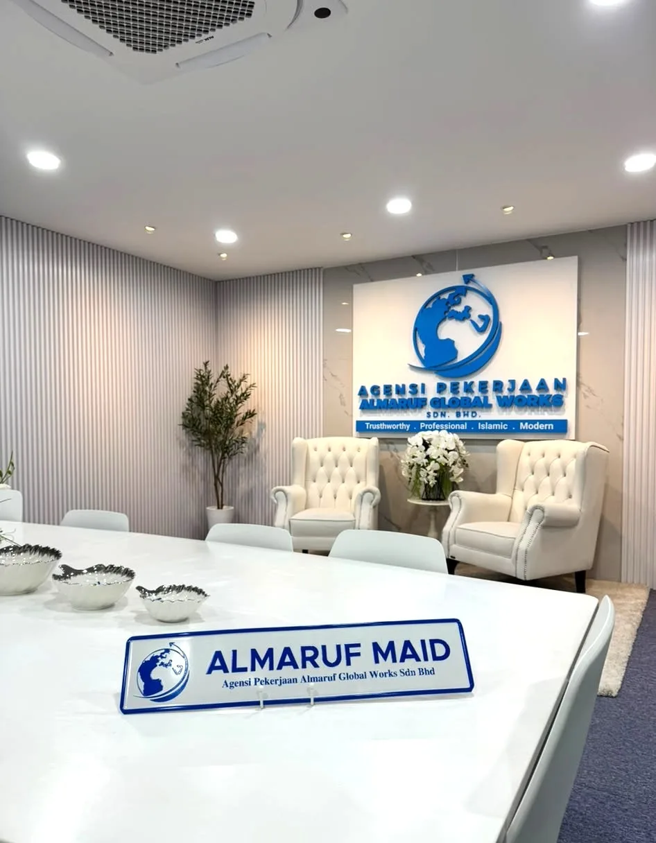 The Almaruf office meeting room, with the Almaruf Maid name plate on the table and the reception sign behind